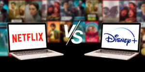 Two laptops display the logos of Netflix and Disney+.