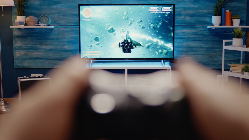 A person holds a game controller.