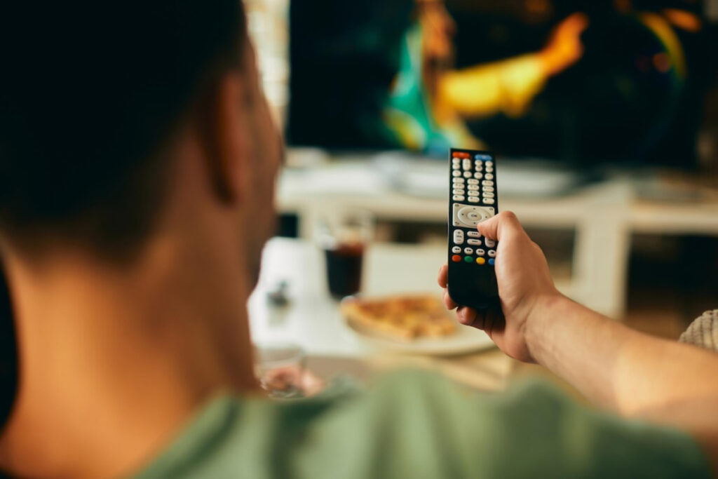 A person holds a remote control.