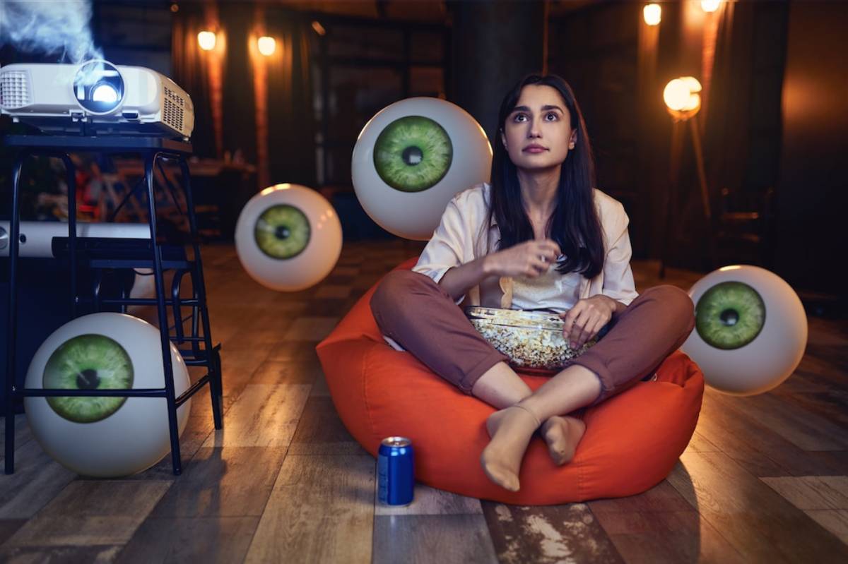 A person sitting on an orange bean bag.